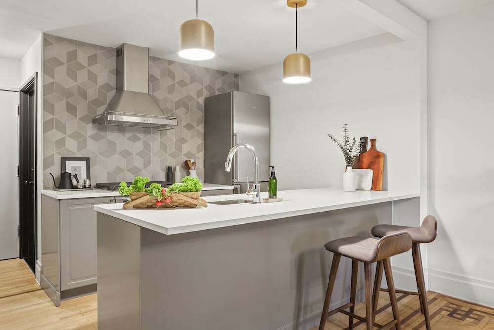 Compact garden-level kitchen and living area in a Brooklyn brownstone, brightly finished