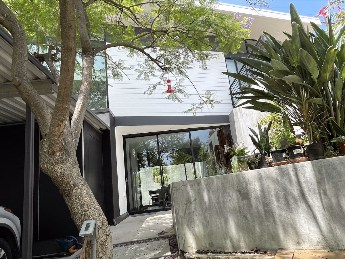 A Los Angeles ADU living space with a wall of sliding glass doors opening onto a patio