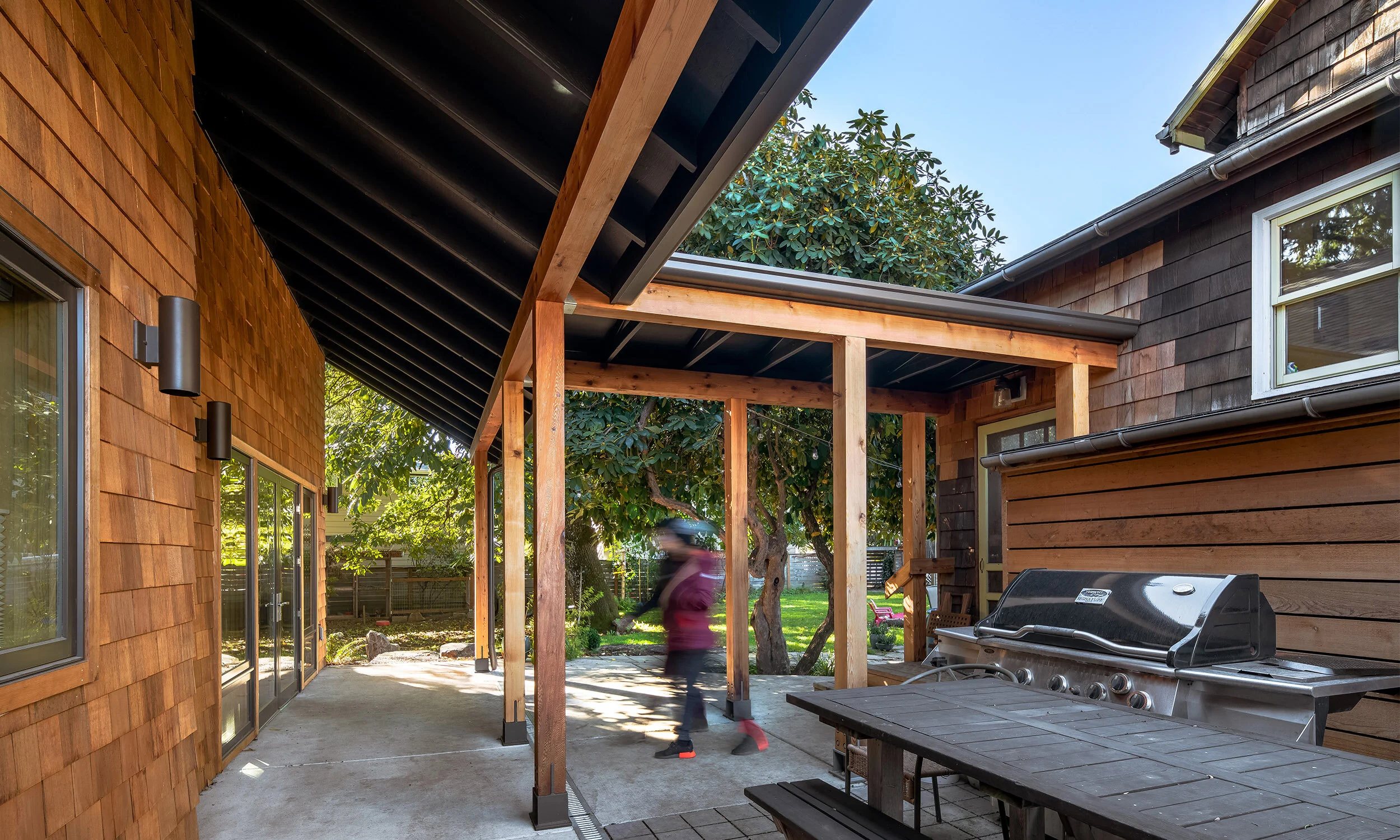 Exterior of the Farmhouse ADU in Portland, a compact two-bedroom accessory dwelling attached to a traditional house by a covered breezeway.