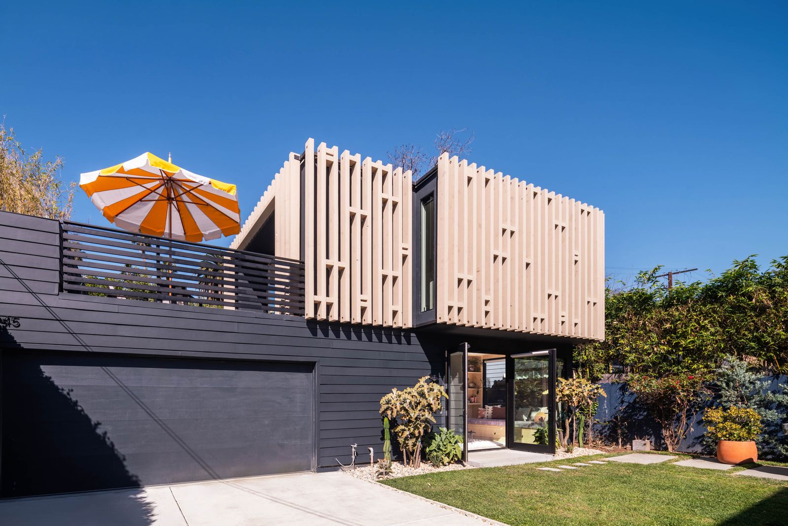 The two-story Textile House ADU with cedar slat cladding over a garage in Silver Lake