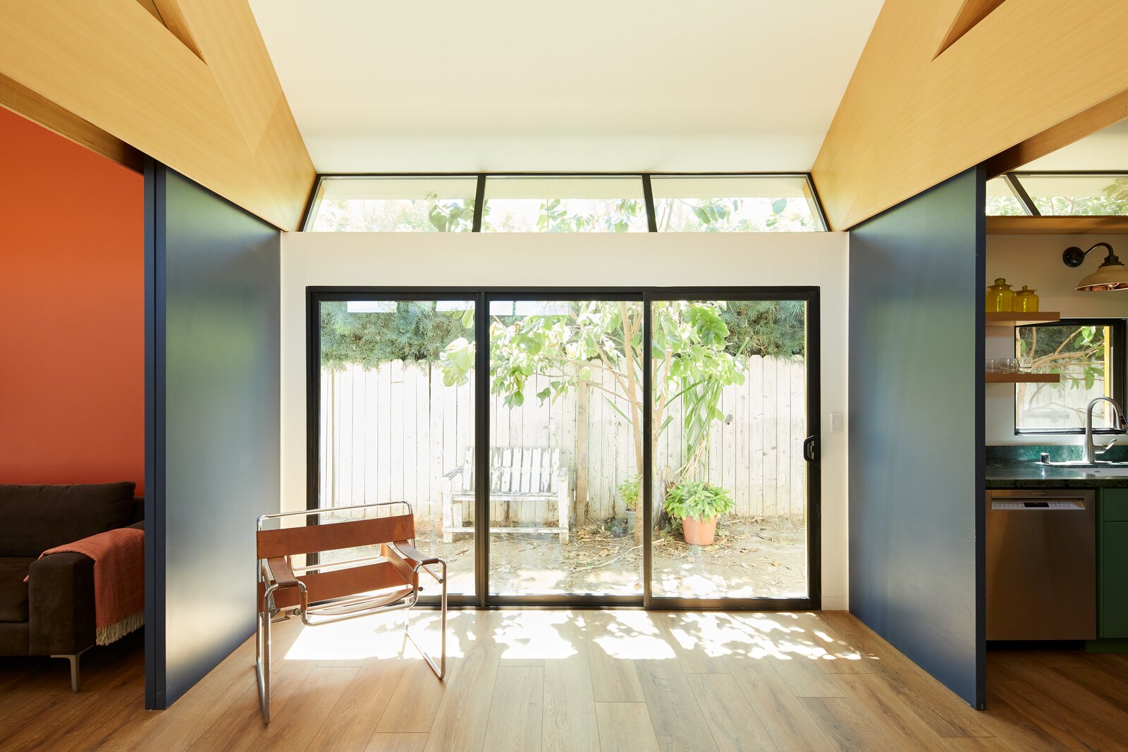 Interior of a compact color-blocked California ADU with sliding doors dividing small rooms