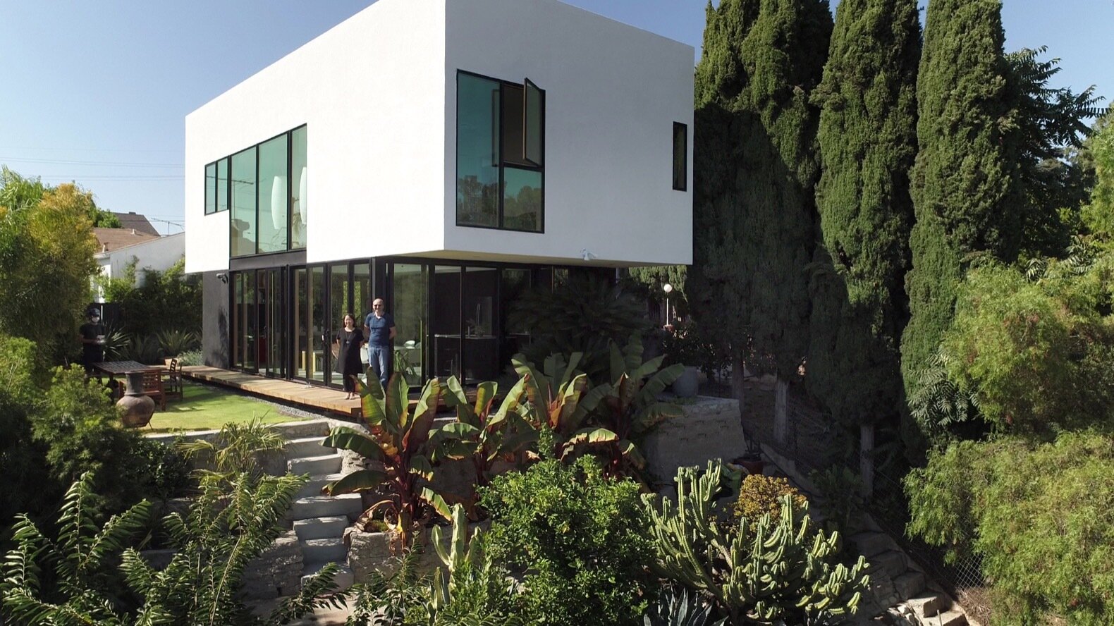 A new detached backyard ADU built in place of a garage on a California lot
