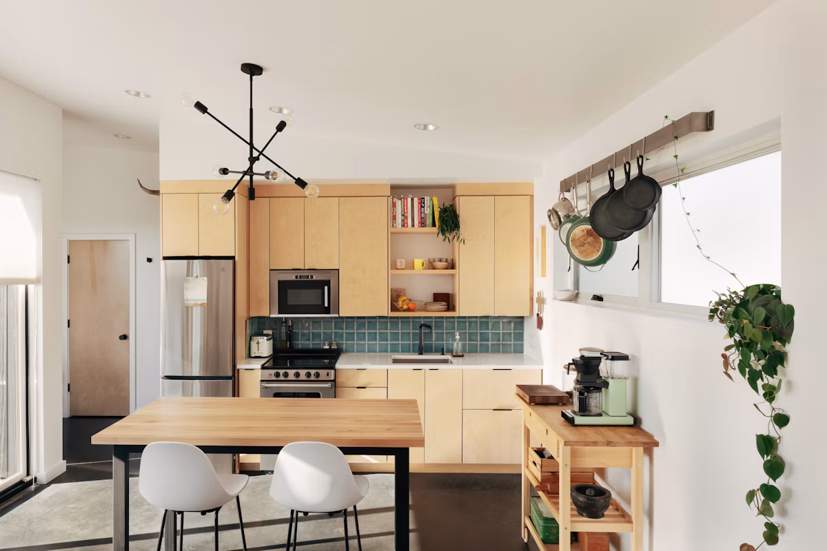 Interior of a compact Seattle detached backyard cottage with wood finishes and full-height windows