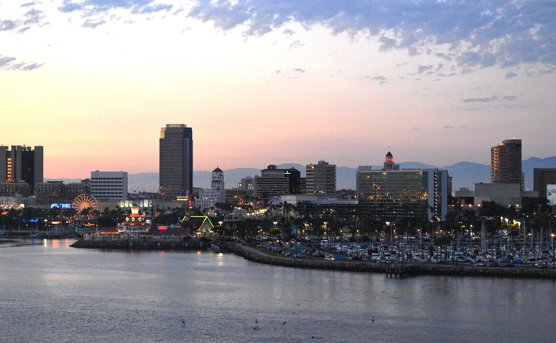 The downtown Long Beach skyline at dusk, seen across the harbor from the Queen Mary